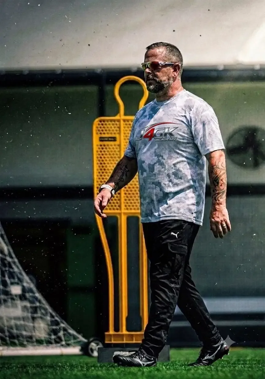 Just4GK coach walking past a training mannequin on the pitch